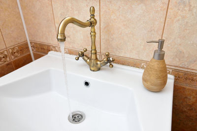 Close-up of faucet in bathroom