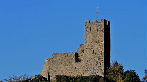 Low angle view of historic building against blue sky