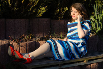 Portrait of young woman sitting outdoors