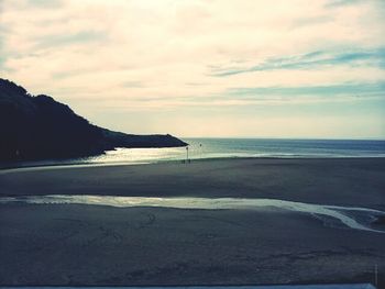 Scenic view of sea against cloudy sky