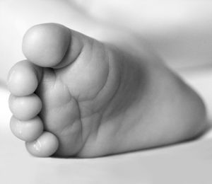 Close-up of baby feet sleeping bed
