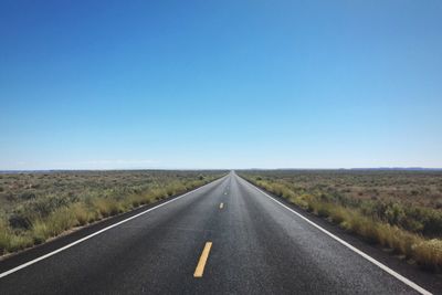 Country road against cloudy sky