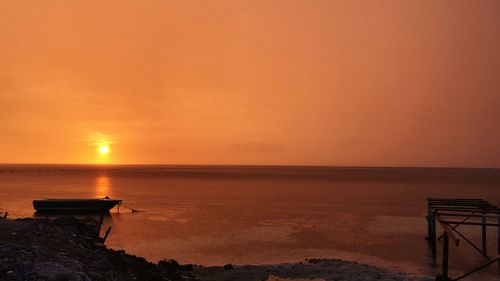 Scenic view of sea against orange sky