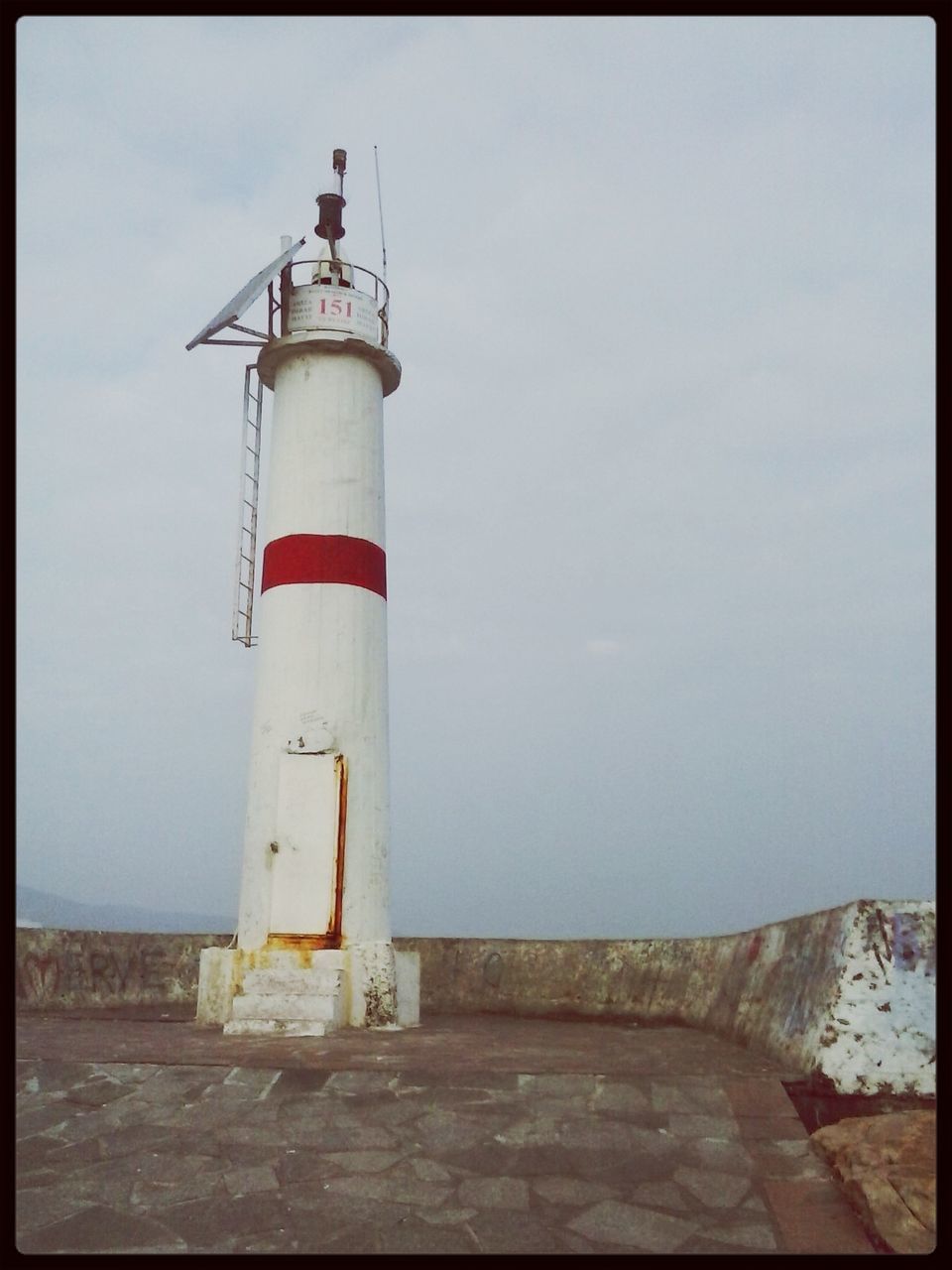 lighthouse, guidance, built structure, architecture, building exterior, protection, safety, direction, security, sea, sky, tower, auto post production filter, day, water, red, outdoors, transfer print, no people, low angle view