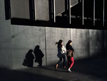 Friends walking on sidewalk