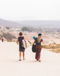 Rear view of couple walking on street