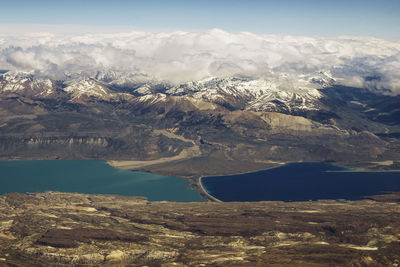 Aerial view of lake and snowcapped mountains against sky