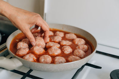 Cropped hand of person preparing food