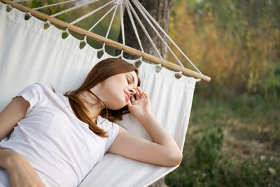 Woman lying on hammock