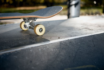 Close-up of skateboard on road