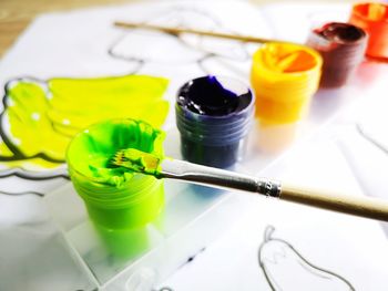 High angle view of paintbrushes in container on table