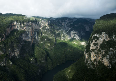 Scenic view of mountains against cloudy sky