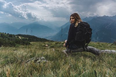 Woman on field against mountain range