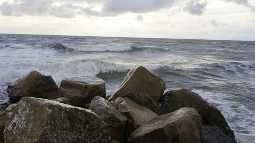 Scenic view of sea against cloudy sky