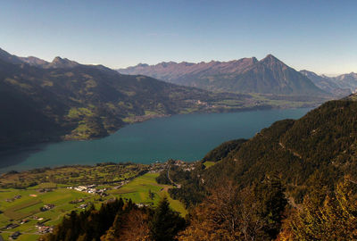 High angle view of sea and mountains against clear sky