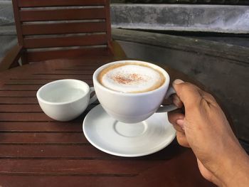 Midsection of coffee cup on table