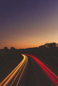 High angle view of light trails on road at night