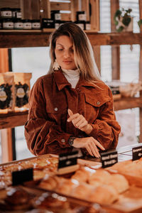 Portrait of young woman standing in bakery 