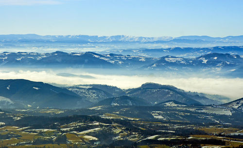 Scenic view of dramatic landscape against sky during winter