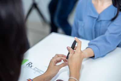 Midsection of woman using mobile phone