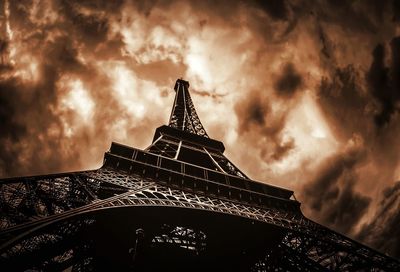 Low angle view of eiffel tower against cloudy sky