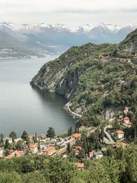 High angle view of town by sea against sky