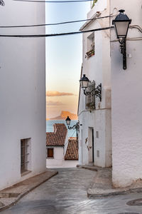 Street light by building against sky