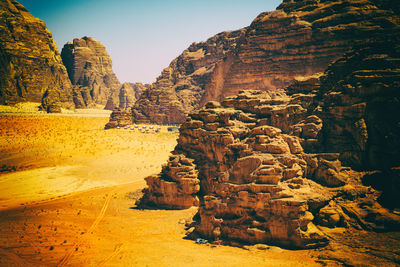 Rock formations on landscape against sky