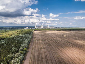 View of factory against cloudy sky