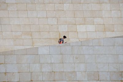 High angle view of woman walking on wall