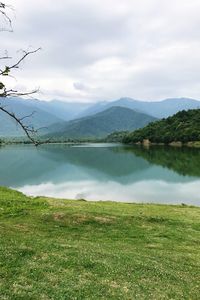 Scenic view of lake and mountains against sky