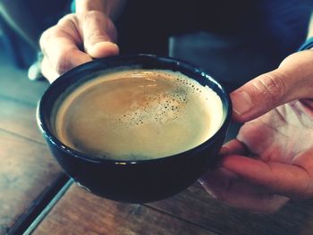 Close-up of hand holding coffee cup