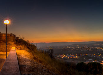 Illuminated city at sunset