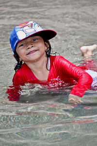 Smiling girl swimming in sea