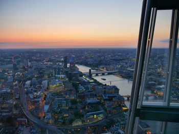 High angle view of city buildings against sky during sunset