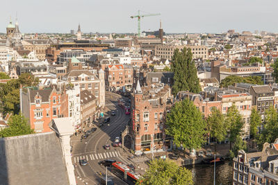 High angle view of buildings and trees against sky