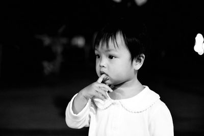 Close-up of girl with finger in mouth