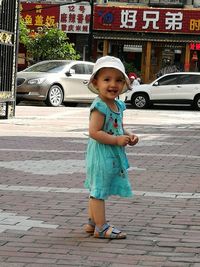 Full length of cute girl on street in city