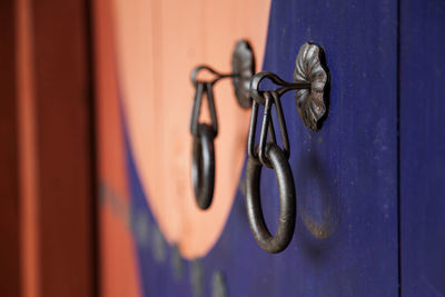 Close-up of knocker on wooden temple door