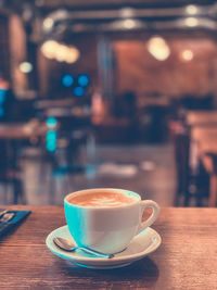 Close-up of coffee served on table at cafe