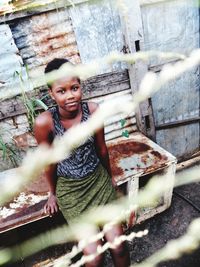 High angle portrait of smiling girl outside house