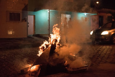 Blurred motion of fire on log at night