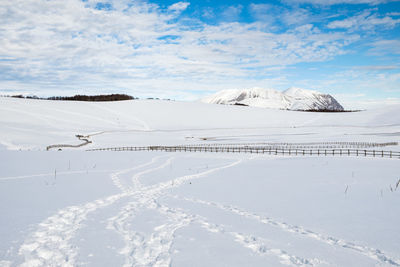 Scenic view of snow covered mountains against sky