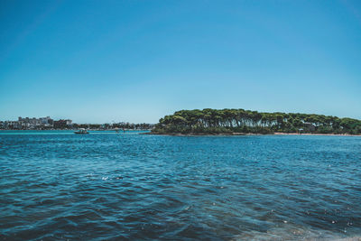 Scenic view of sea against clear blue sky