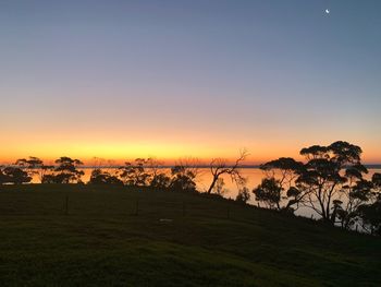 Scenic view of field against sky during sunset