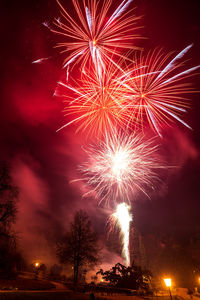 Low angle view of firework display at night