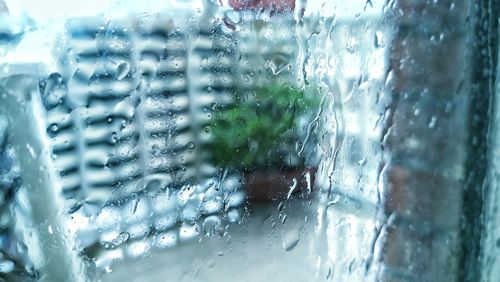 Close-up of wet glass window in rainy season