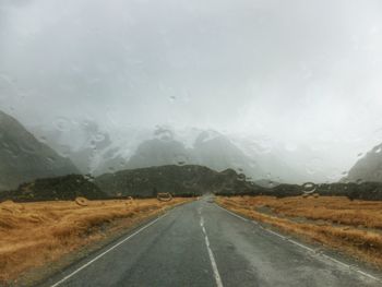 Road and mountain seen through car windshield