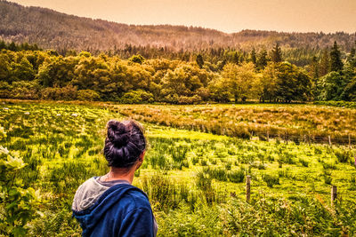 Rear view of woman working in field