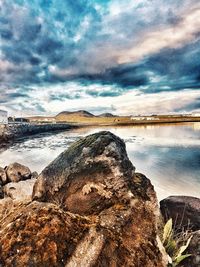 Rocks on beach against sky